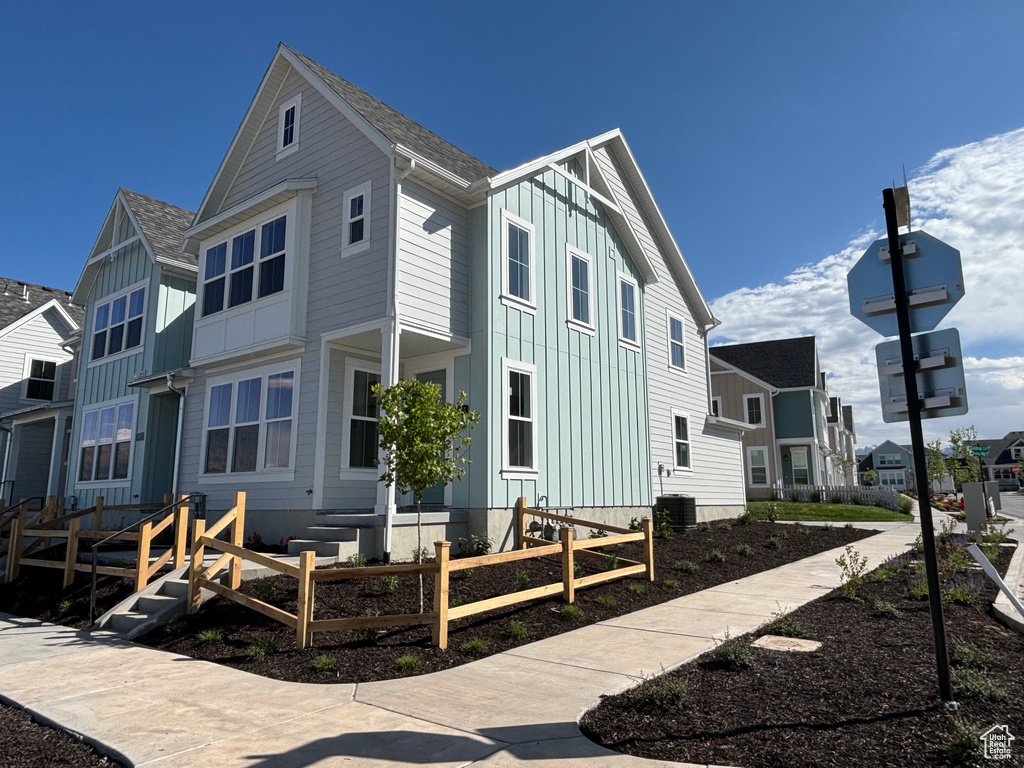 View of side of property with board and batten siding and a residential view