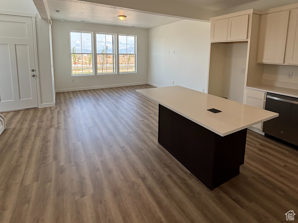 Kitchen featuring dishwasher, dark wood finished floors, open floor plan, light countertops, and recessed lighting