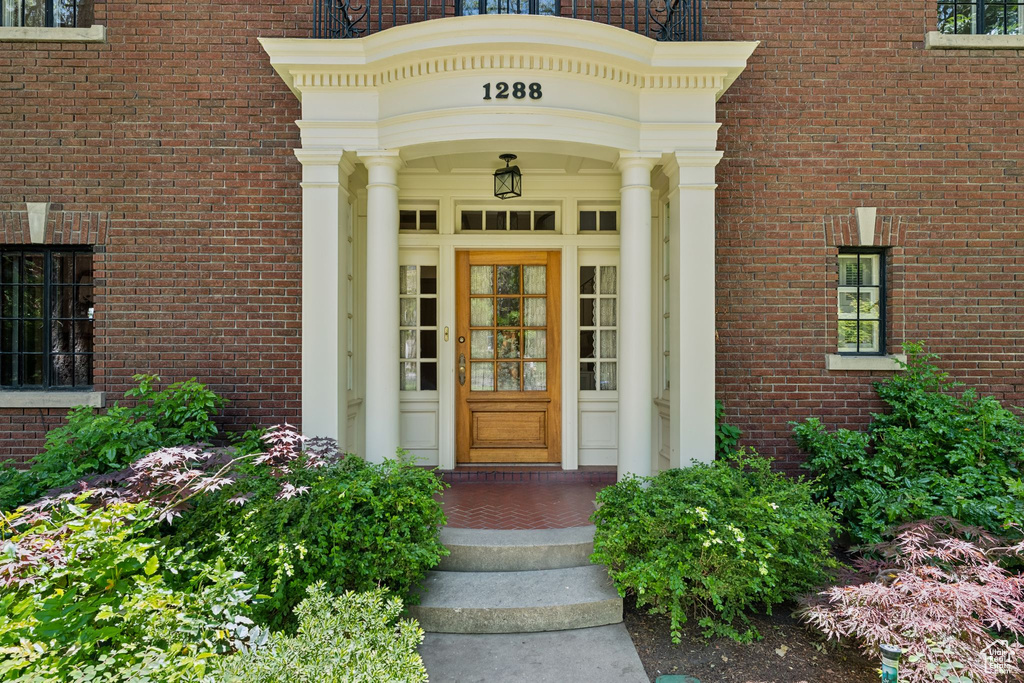 View of exterior entry with brick siding