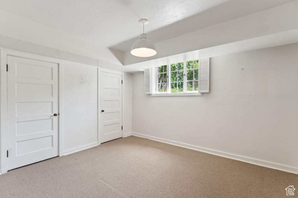 Basement featuring carpet floors and baseboards