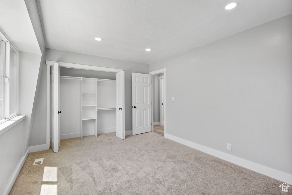Unfurnished bedroom featuring carpet flooring, recessed lighting, and baseboards