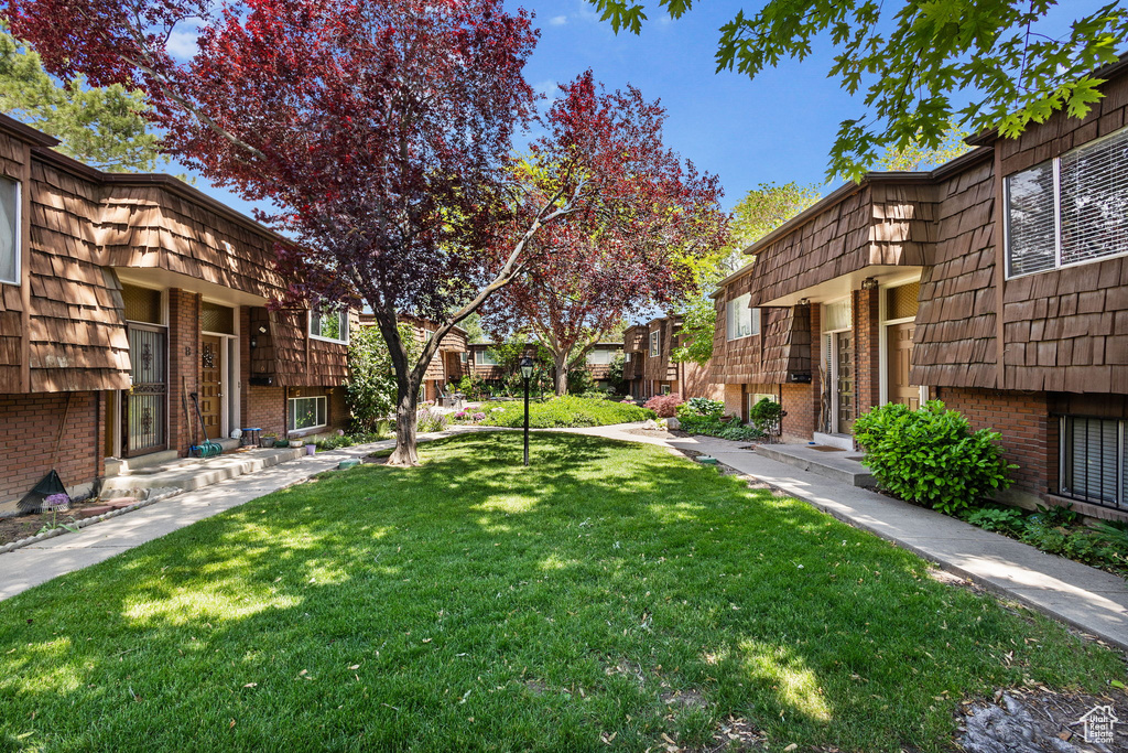 View of green lawn featuring a residential view