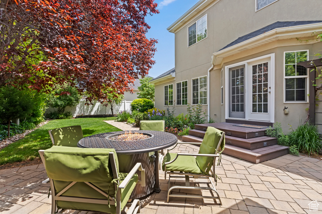 View of patio with an outdoor fire pit