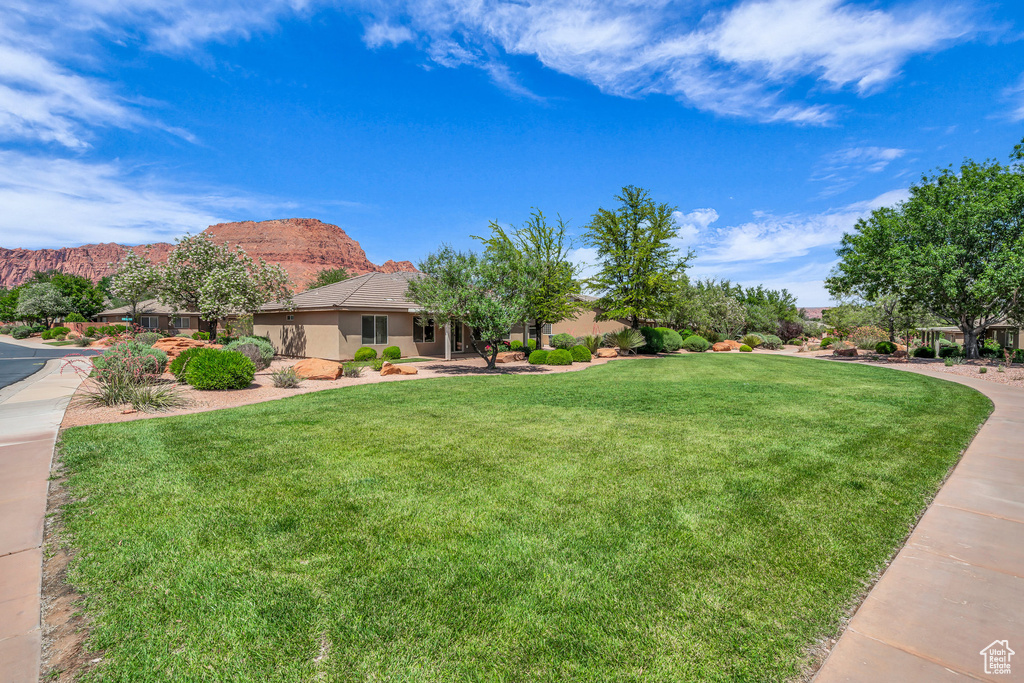 View of grassy yard with a mountain view