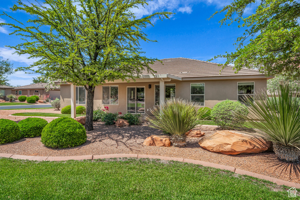 Single story home featuring stucco siding and a tiled roof
