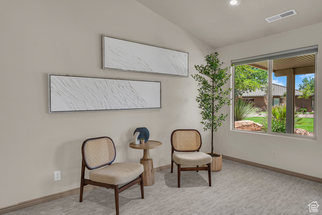 Living area featuring baseboards, lofted ceiling, carpet floors, and recessed lighting
