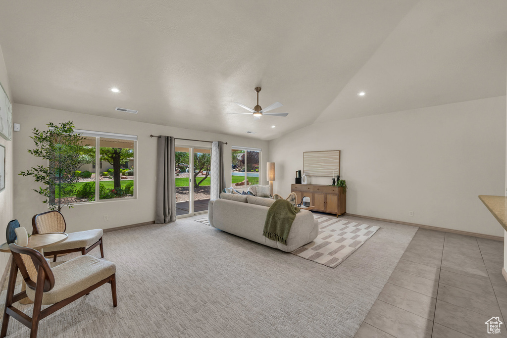 Living room with a ceiling fan, recessed lighting, vaulted ceiling, baseboards, and light tile patterned flooring