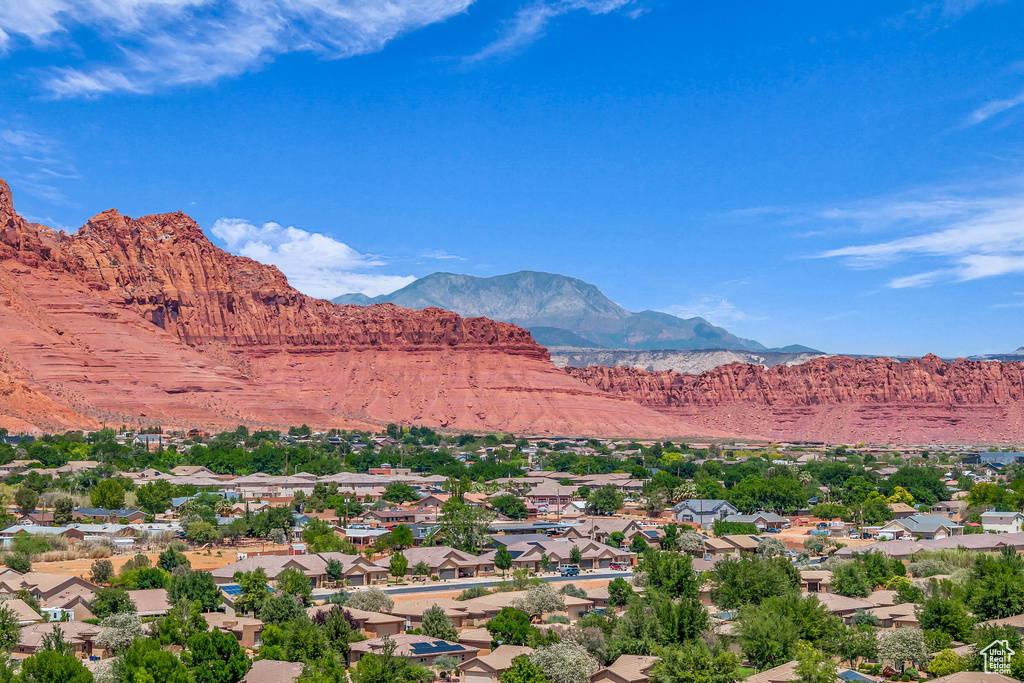 View of mountain backdrop featuring nearby suburban area