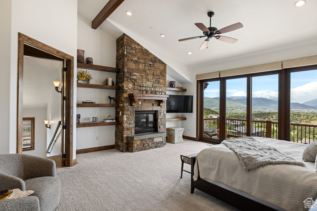 Carpeted bedroom featuring access to exterior, baseboards, a stone fireplace, and recessed lighting