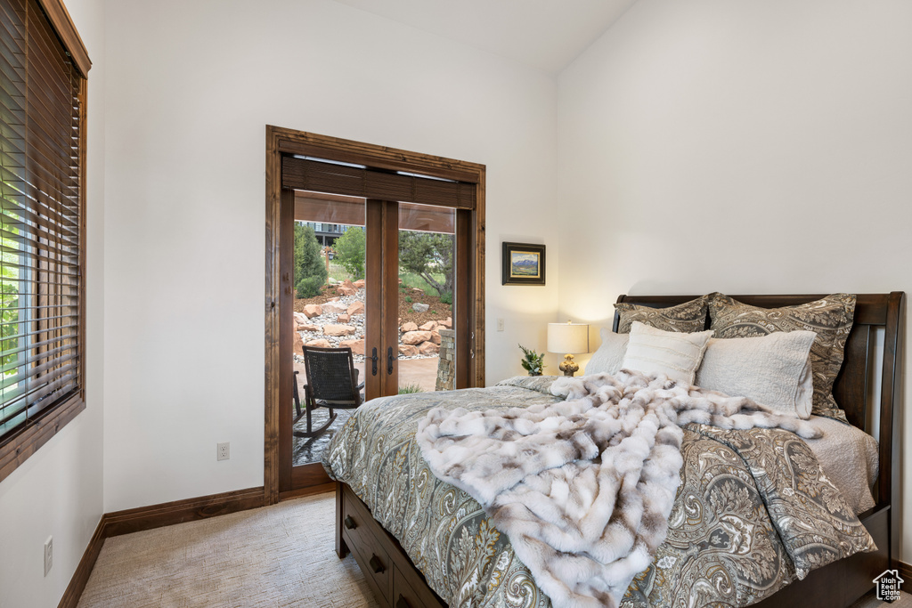 Bedroom with carpet, access to exterior, baseboards, french doors, and lofted ceiling