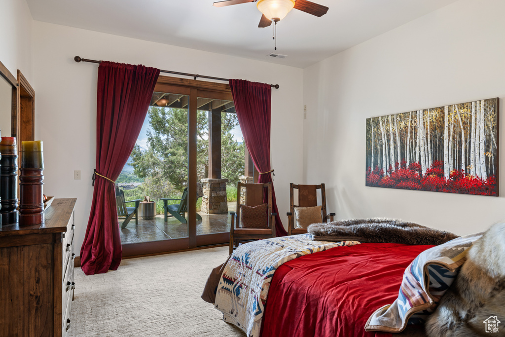 Carpeted bedroom featuring access to exterior and a ceiling fan