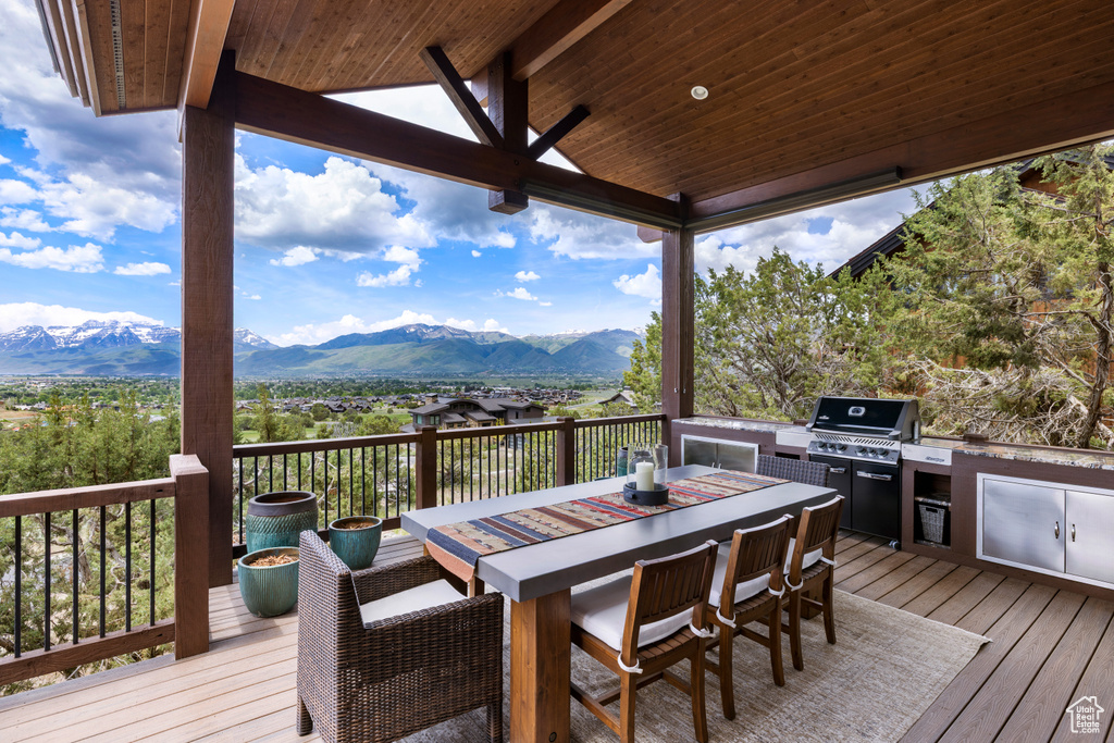 Deck featuring a mountain view and outdoor dining area