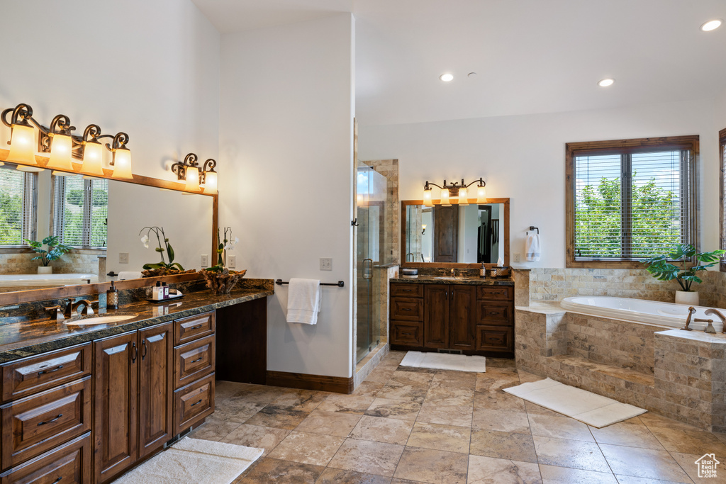Full bathroom featuring a garden tub, vanity, a stall shower, baseboards, and recessed lighting