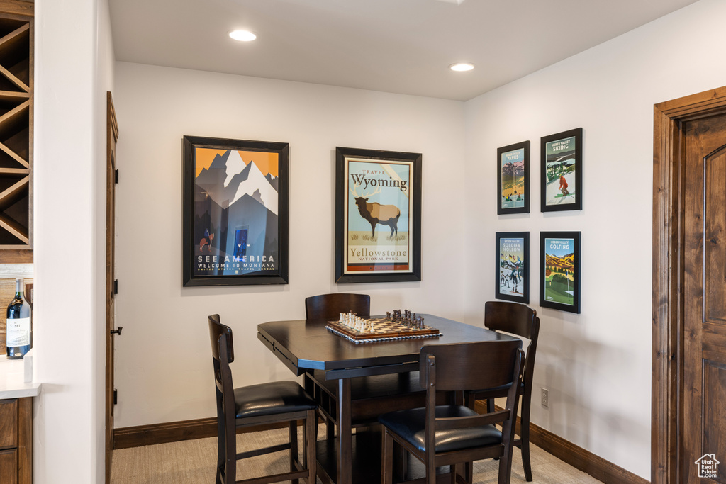 Dining area with baseboards, wood finished floors, and recessed lighting