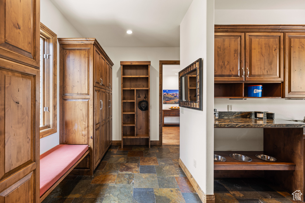 Mudroom featuring stone tile flooring, baseboards, and recessed lighting
