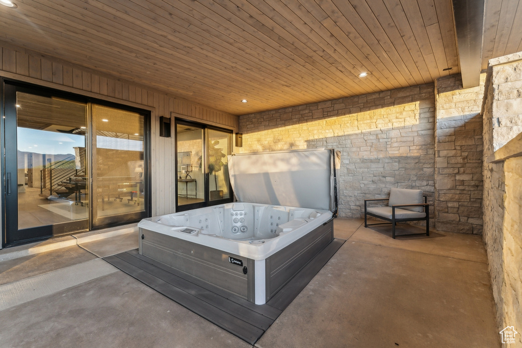 View of patio with a hot tub