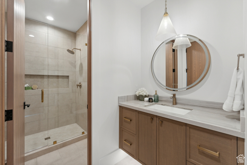 Full bath with vanity and a shower stall