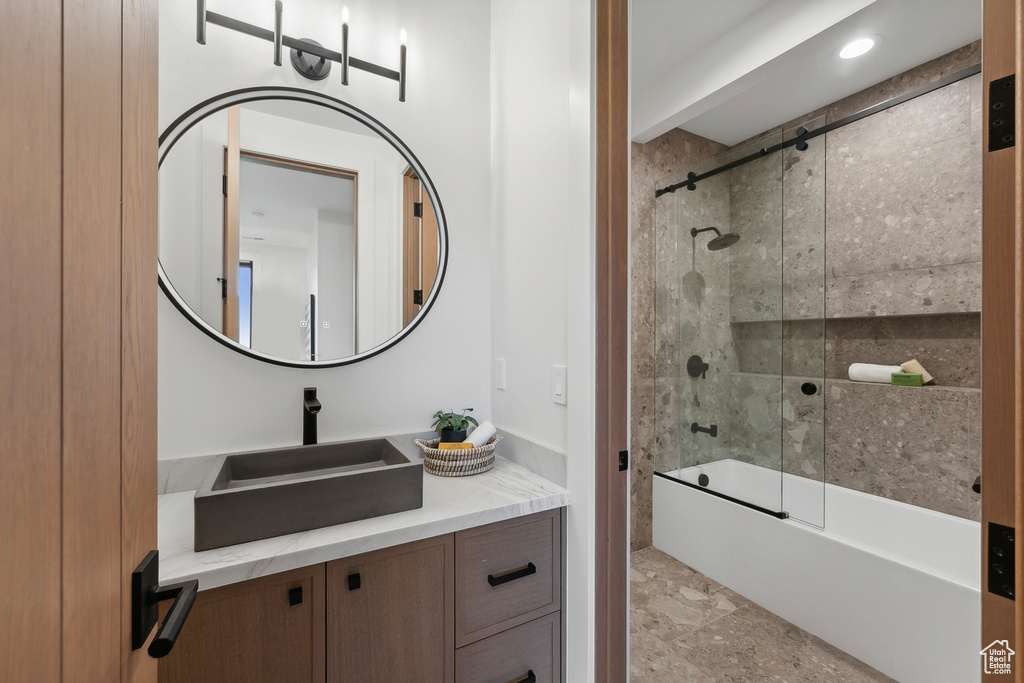 Full bath featuring shower / bath combination with glass door, vanity, and recessed lighting