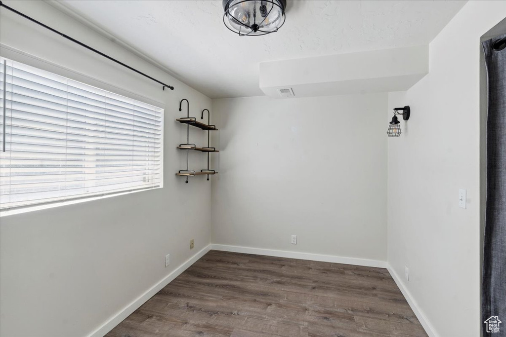 Unfurnished room featuring wood finished floors and baseboards