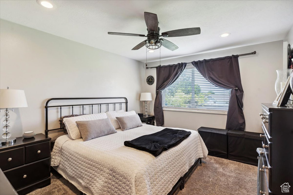 Carpeted bedroom featuring recessed lighting and a ceiling fan