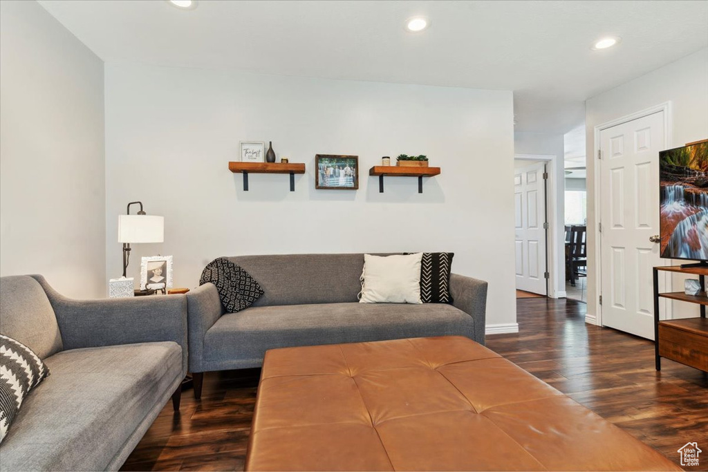 Living area with dark wood-style floors and recessed lighting