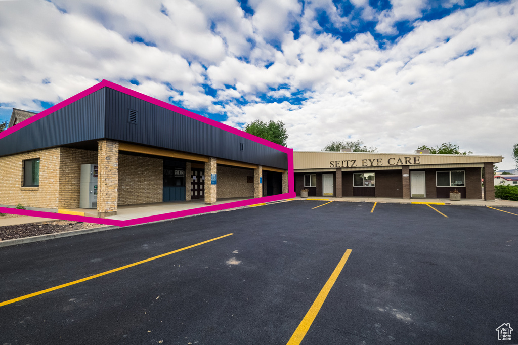 View of building exterior with uncovered parking