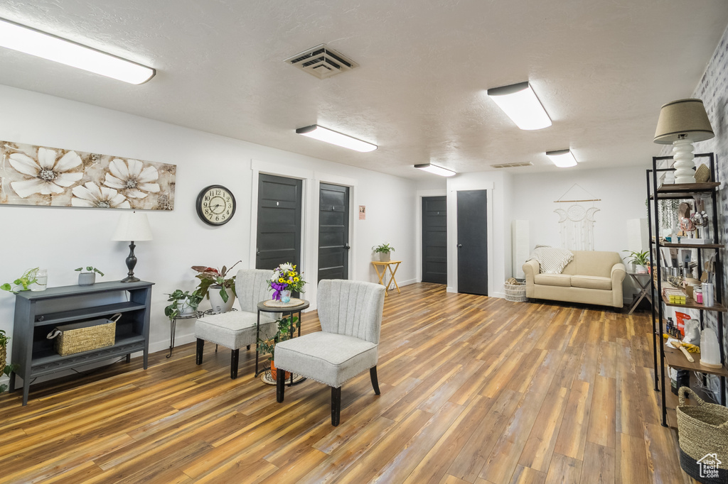 Sitting room featuring wood finished floors and baseboards