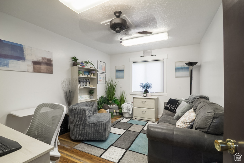 Office with wood finished floors, a ceiling fan, and a textured ceiling