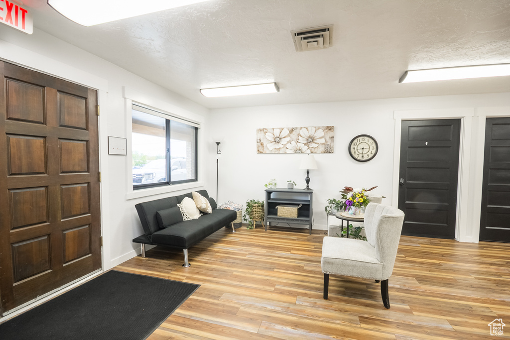 Living area with light wood finished floors and baseboards