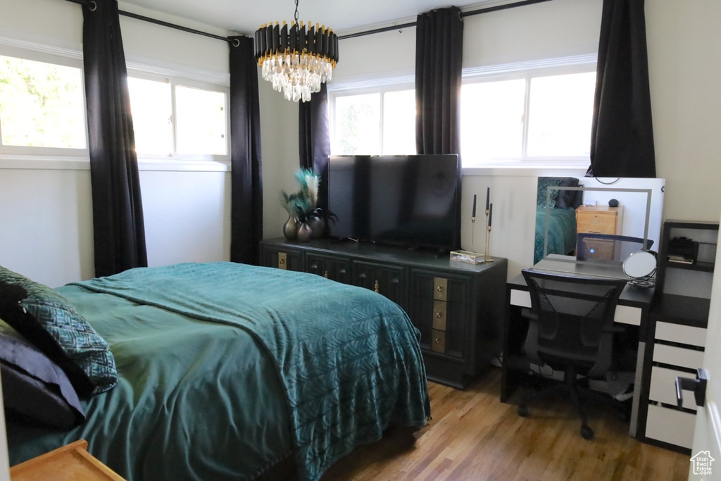 Bedroom with light wood-style flooring and a chandelier
