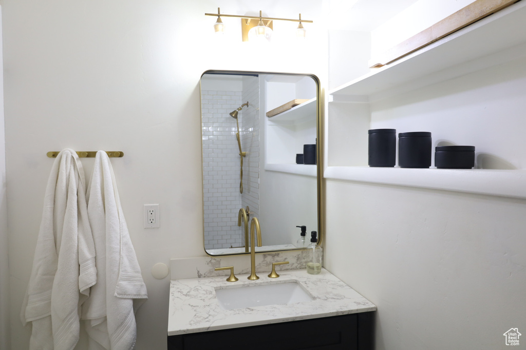 Bathroom featuring vanity and tiled shower