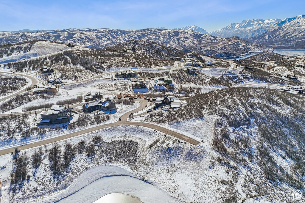 Snowy aerial view featuring a mountain view