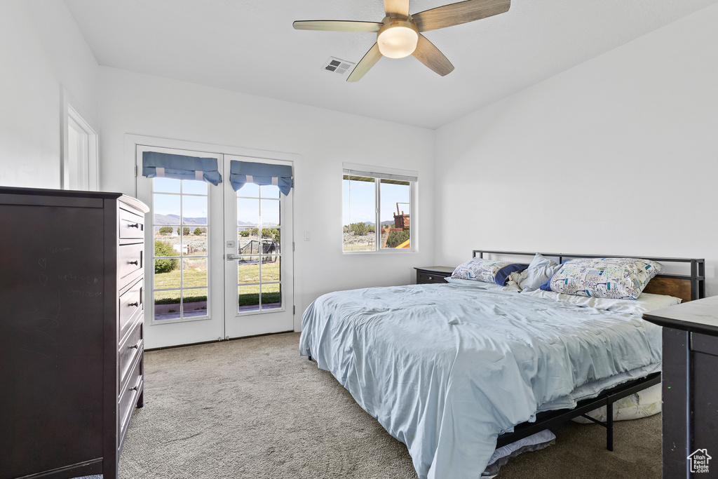 Bedroom with carpet floors, access to exterior, ceiling fan, and french doors