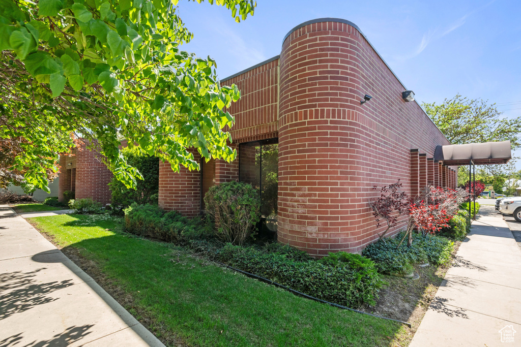 View of property exterior with brick siding