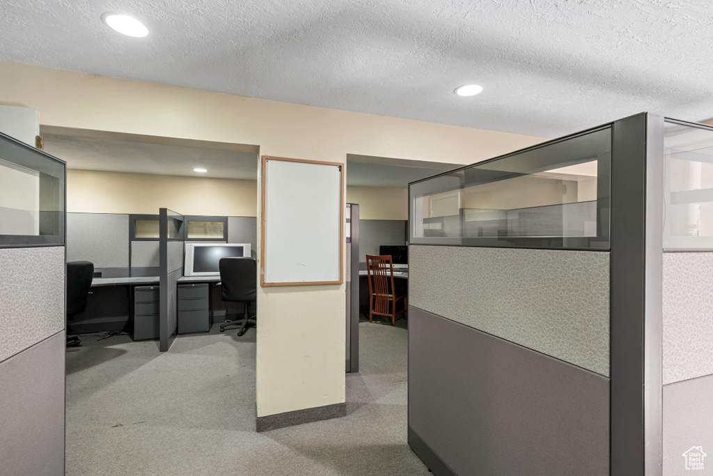 Office space with recessed lighting, carpet, and a textured ceiling