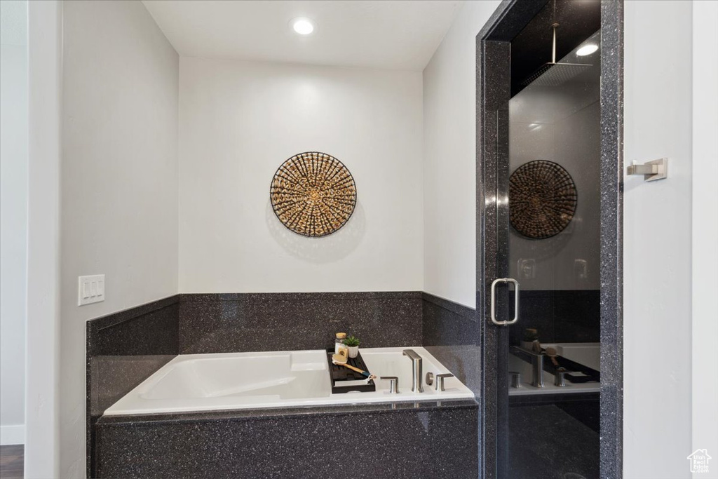 Full bathroom with a stall shower, a garden tub, and recessed lighting