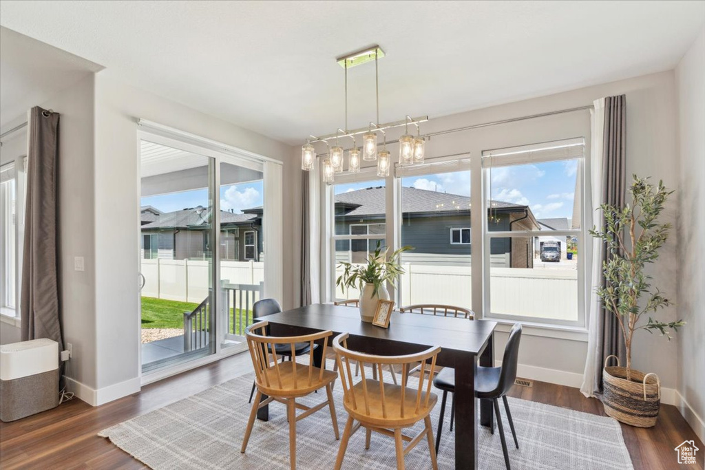 Dining area featuring baseboards and dark wood-type flooring