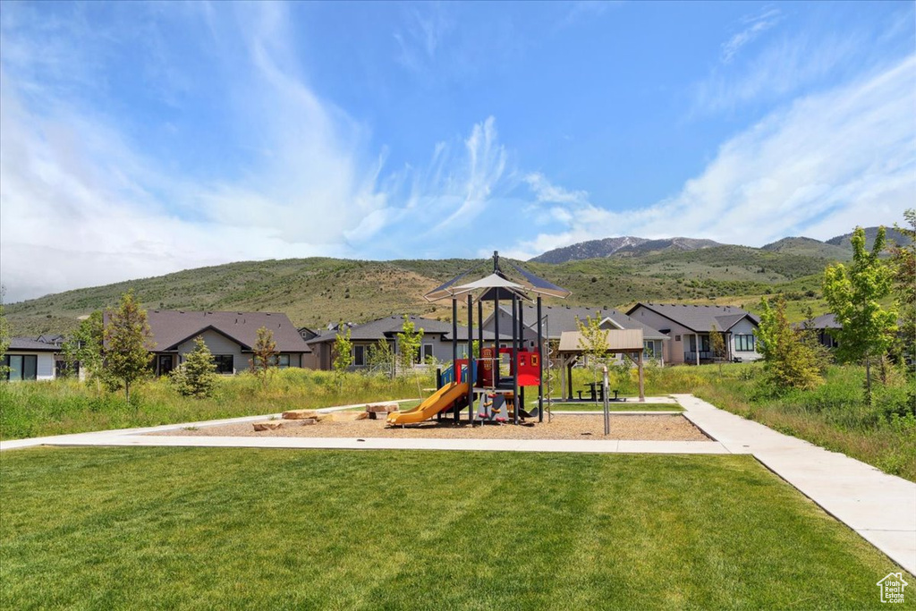 Communal playground with a yard, a mountain view, and a residential view