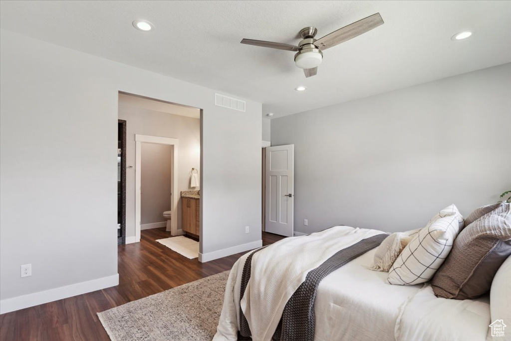 Bedroom with dark wood-style floors, baseboards, recessed lighting, a ceiling fan, and connected bathroom