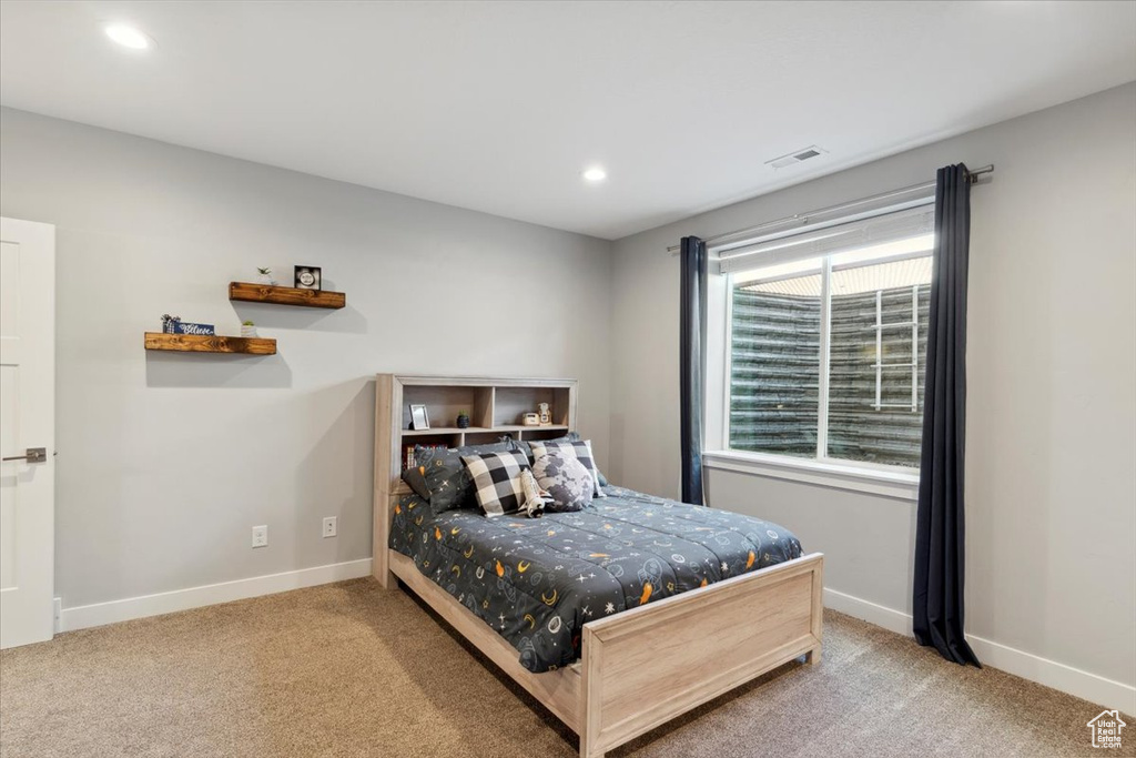 Bedroom with carpet floors, baseboards, and recessed lighting