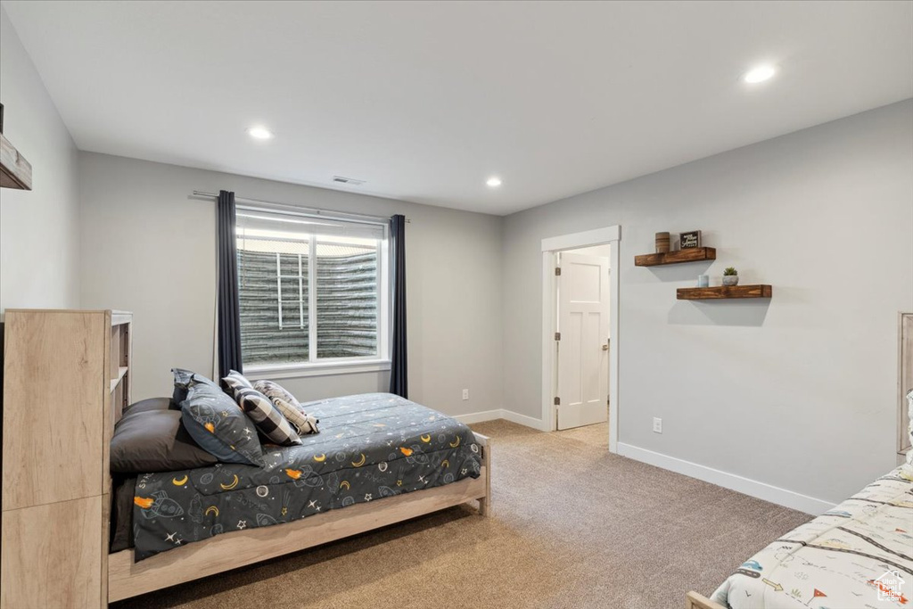 Carpeted bedroom with baseboards and recessed lighting