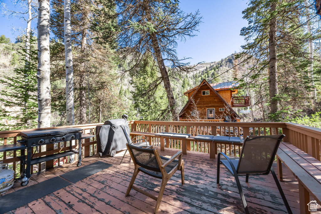 Wooden deck with a mountain view and an outdoor structure