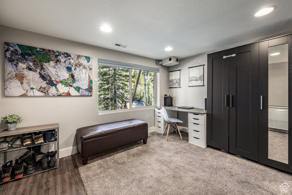 Office space featuring baseboards, recessed lighting, and wood finished floors