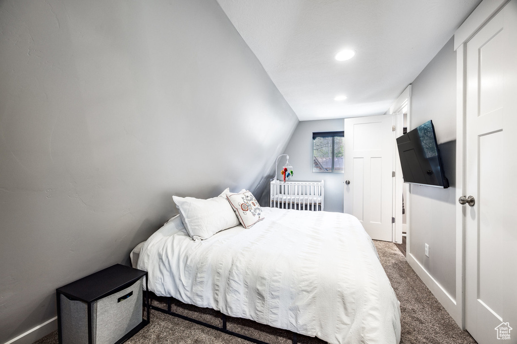 Bedroom featuring dark carpet, recessed lighting, baseboards, and vaulted ceiling