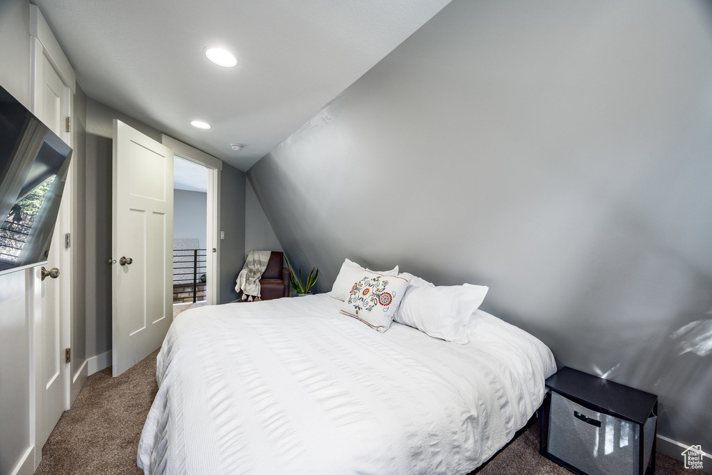 Carpeted bedroom featuring baseboards, recessed lighting, and lofted ceiling