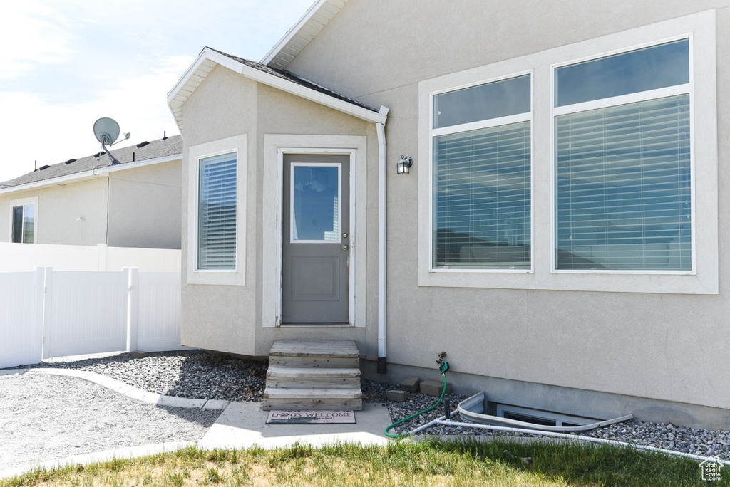 Entrance to property featuring stucco siding