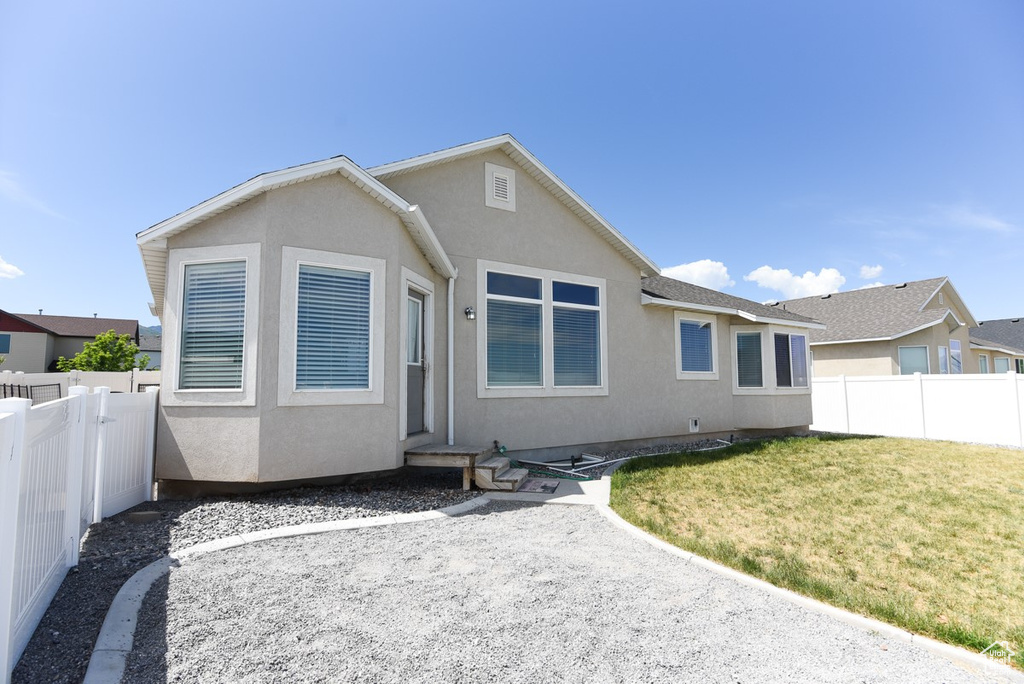 Back of house featuring stucco siding