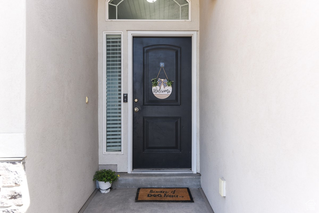 Entrance to property with stucco siding