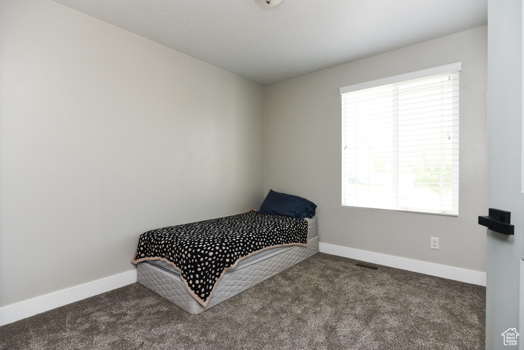 Carpeted bedroom featuring baseboards