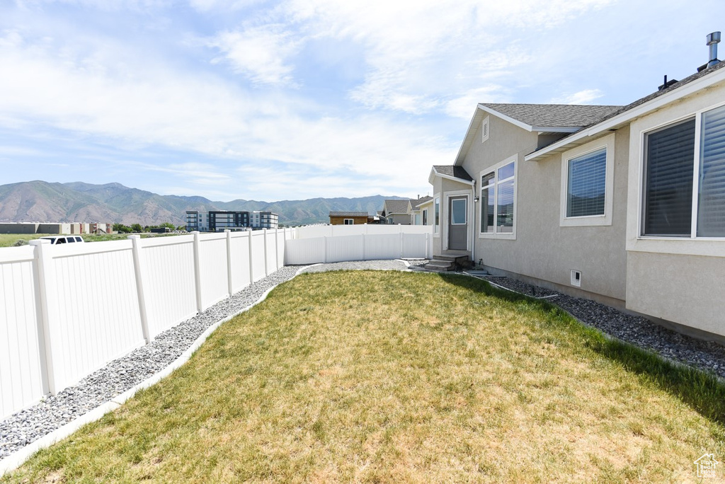 View of yard with a mountain view and entry steps